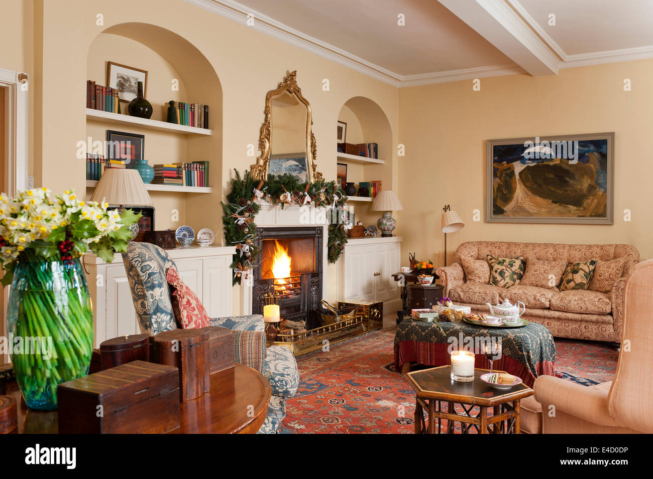 Cosy sitting room with fireplace and assorted antique furniture. The