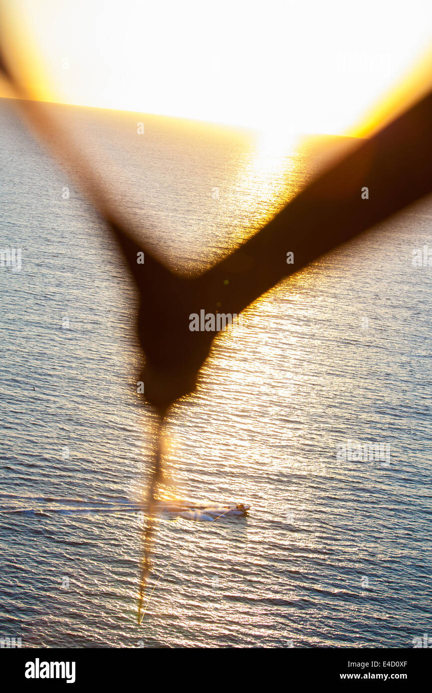 Flying into the sunset on a parachute pulled by a boat in Mazatlan, Mexico. Stock Photo