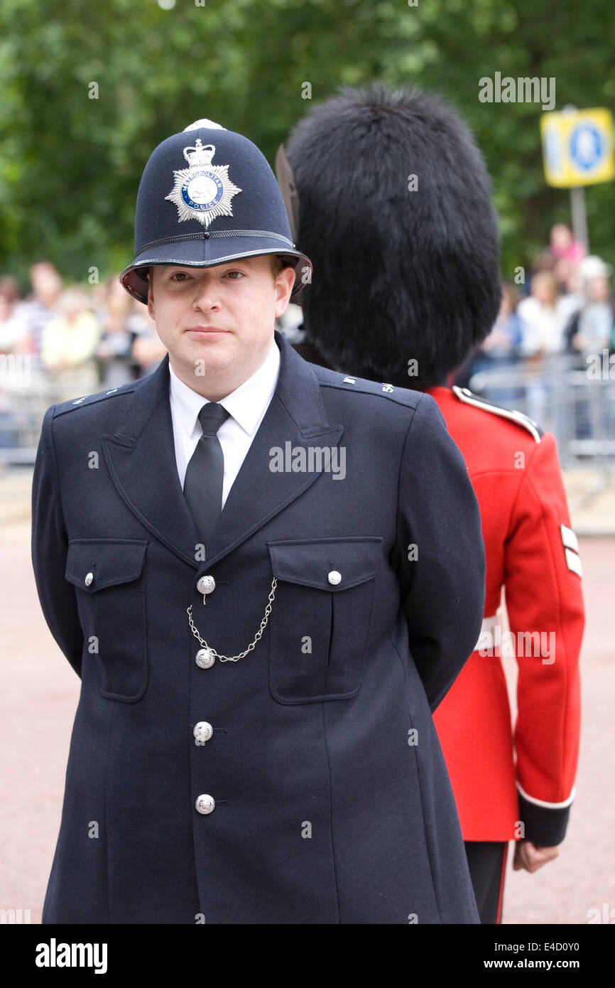 Queens Foot Solider standing in front of an amused police officer along the Mall for Trooping the Colour London England Stock Photo