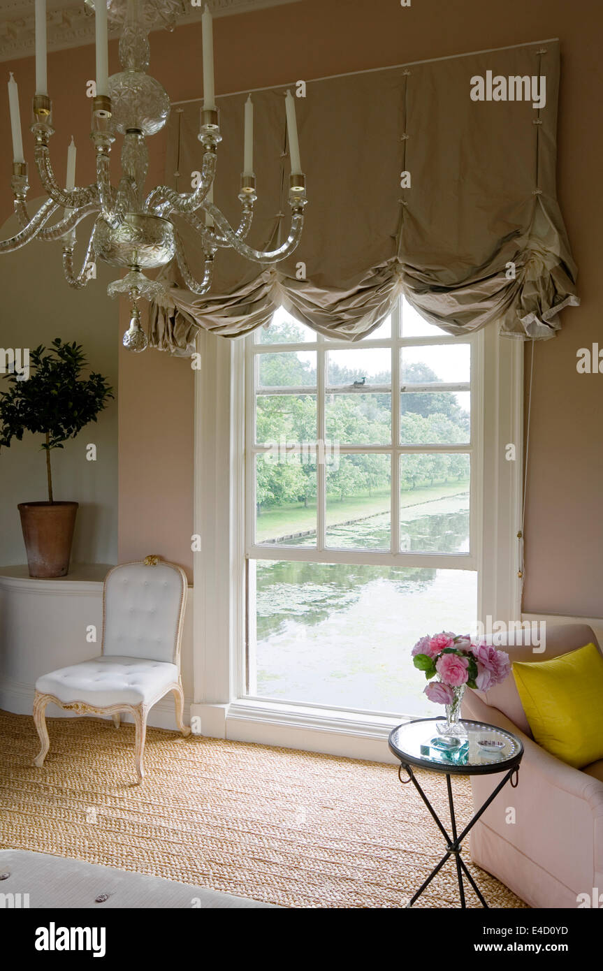 Chandelier and festoon blinds made of Mary Fox Linton satin and Tissus d'Helene taffeta in grand salon with floor length windows Stock Photo