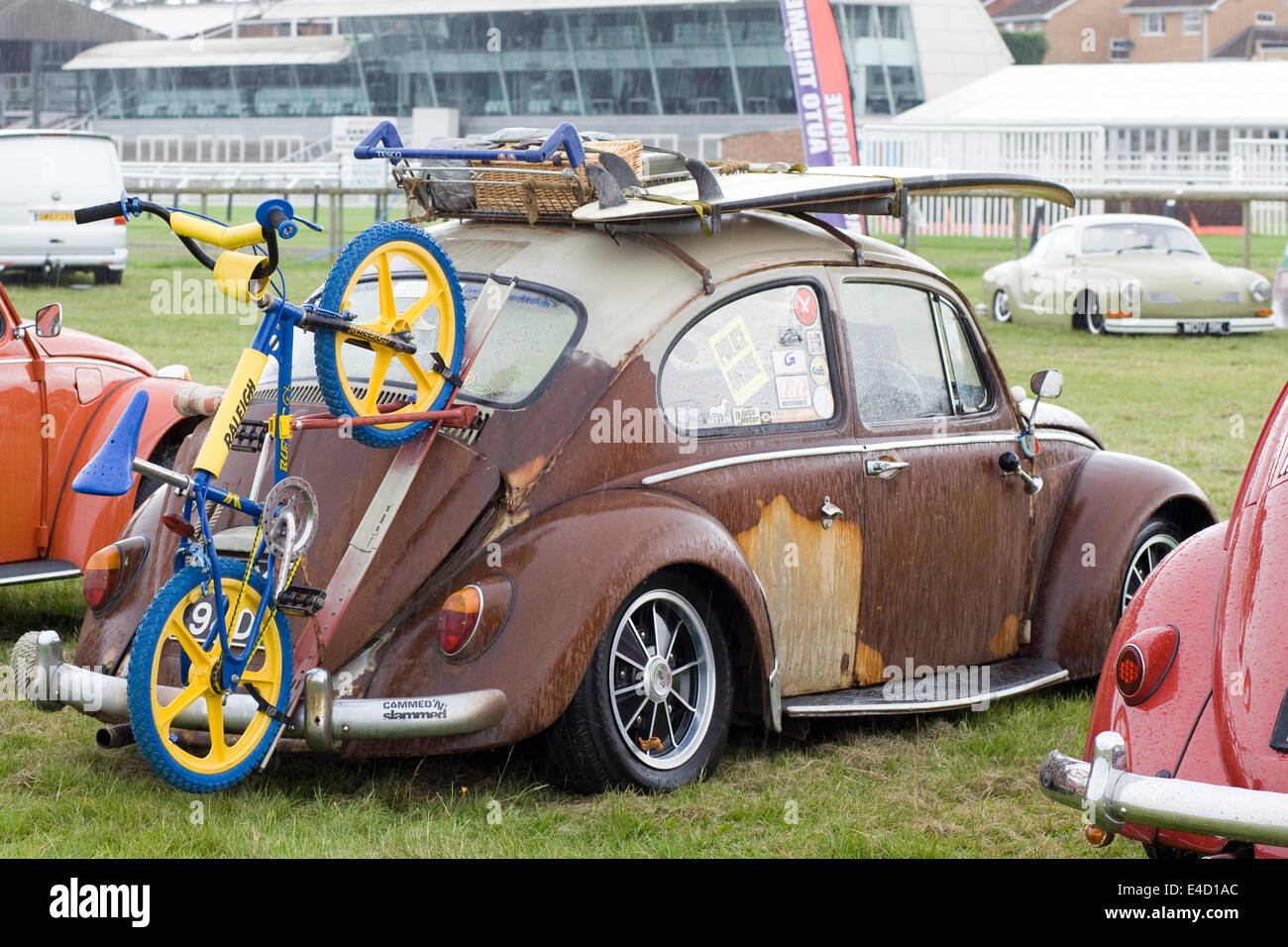 Rat Volkswagen Beetle on a campsite with a Raleigh Bicycle attached to the boot Stock Photo