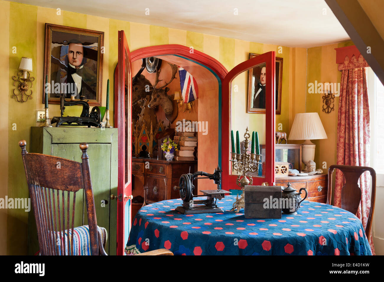 Old Sewing Machine On Patchwork Tablecloth In Room With