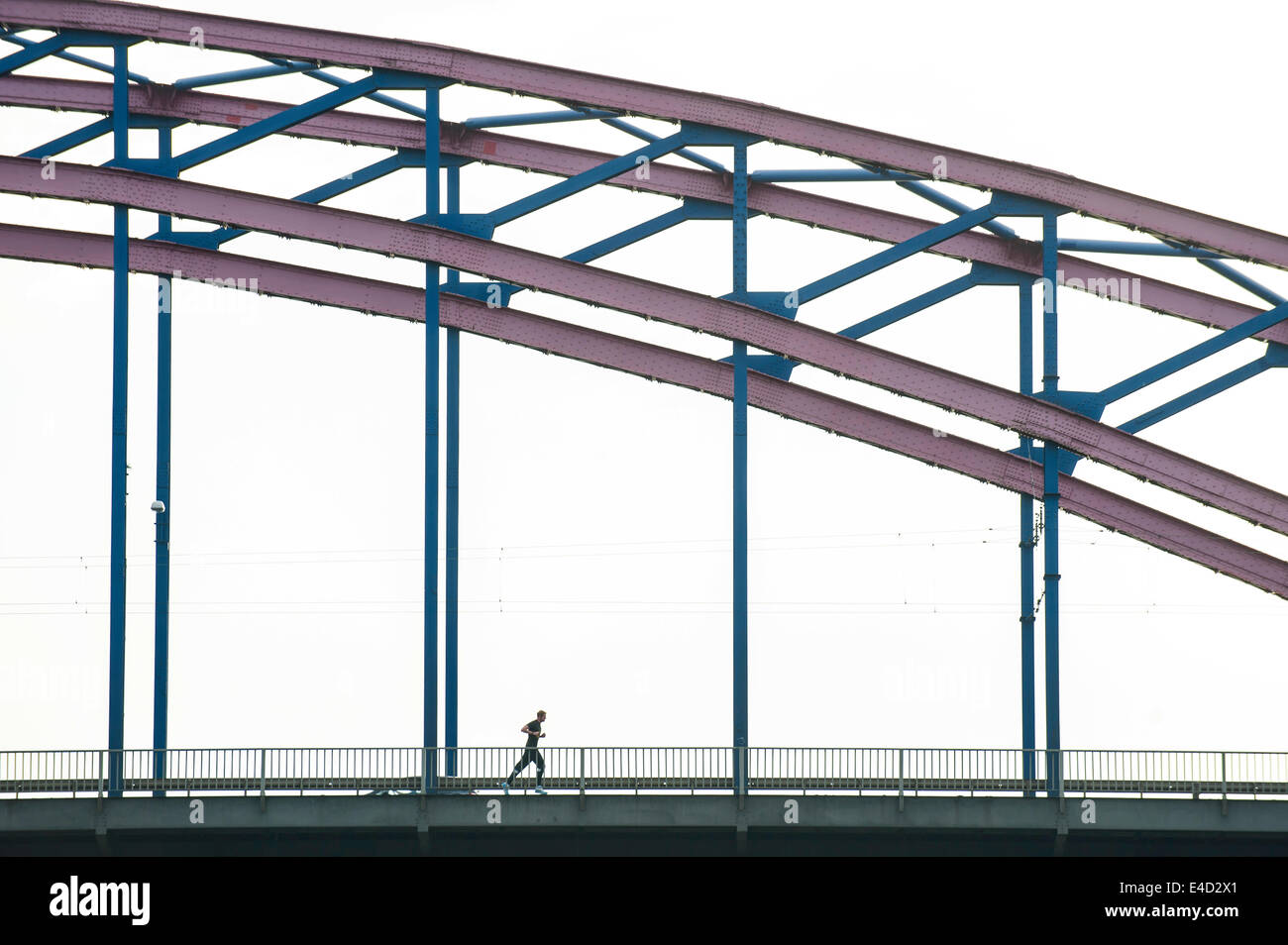 A jogger on a canal bridge, Duisburg, Ruhr district, North Rhine-Westphalia, Germany Stock Photo