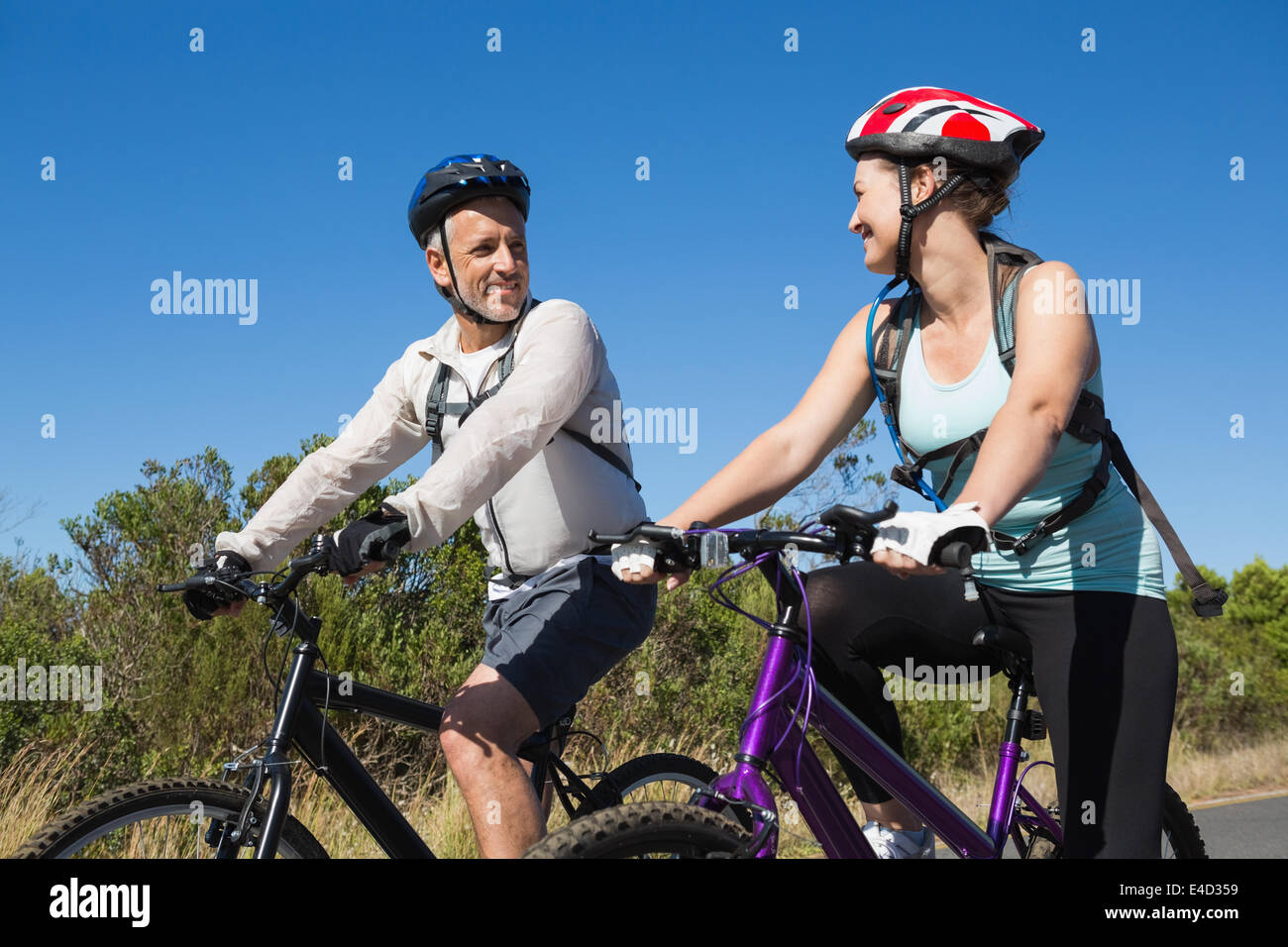 Active couple going for a bike ride in the countryside Stock Photo