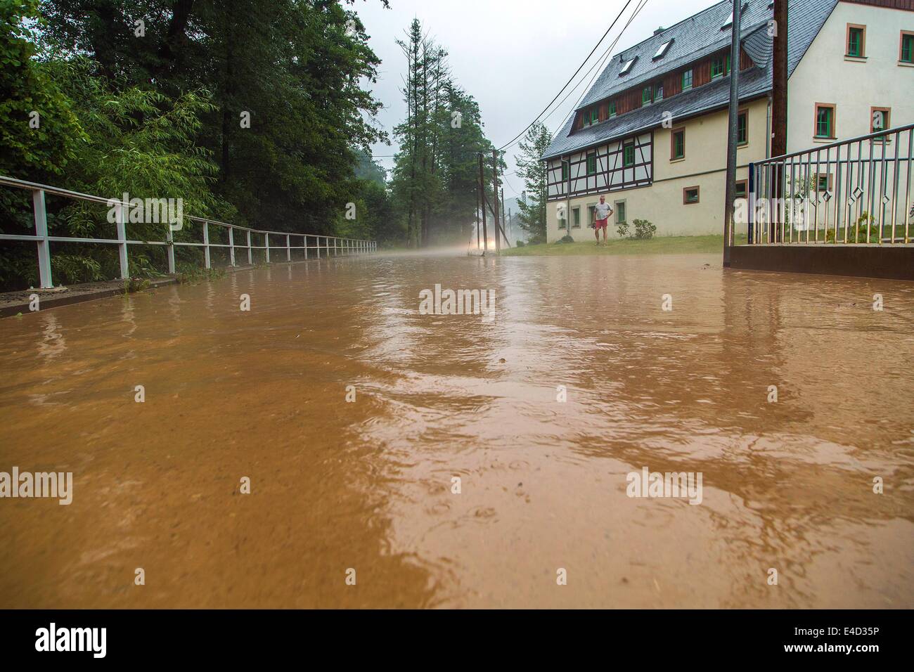 Muehlau, Germany. 09th July, 2014. A flooded street in Muehlau, Germany, 09 Juli 2014. Storms with heavy rainfalls flooded streets and basements in Saxony, Saxony-Anhalt and Thuringia in the night before Wednesday. Photo: Jens Uhlig/dpa/Alamy Live News Stock Photo