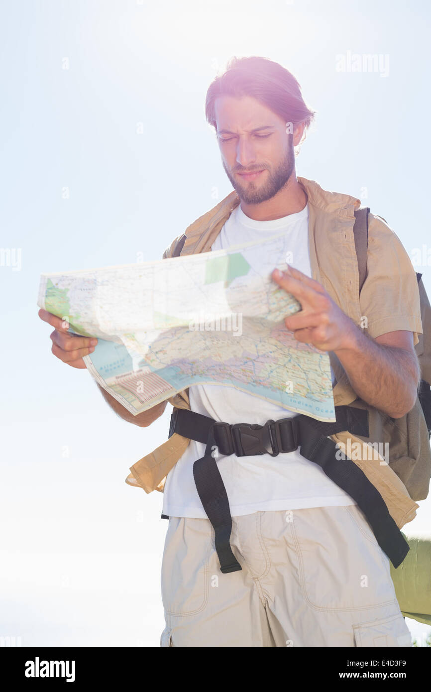 Handsome hiker reading map on mountain trail Stock Photo - Alamy