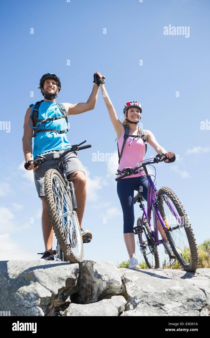 Fit cyclist couple happy to have reached the summit Stock Photo
