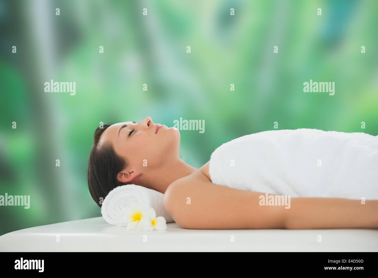 Beautiful brunette relaxing on massage table Stock Photo - Alamy