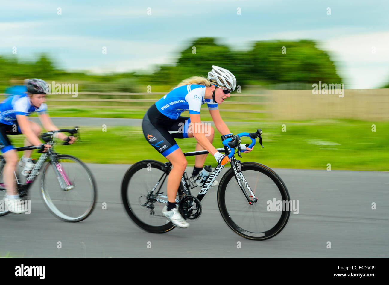 Cyclists racing in women’s criterium event on dedicated cycle circuit ...