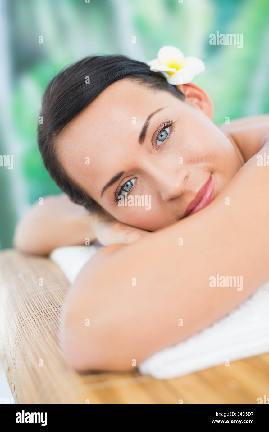 Beautiful brunette relaxing on massage table smiling at camera Stock Photo