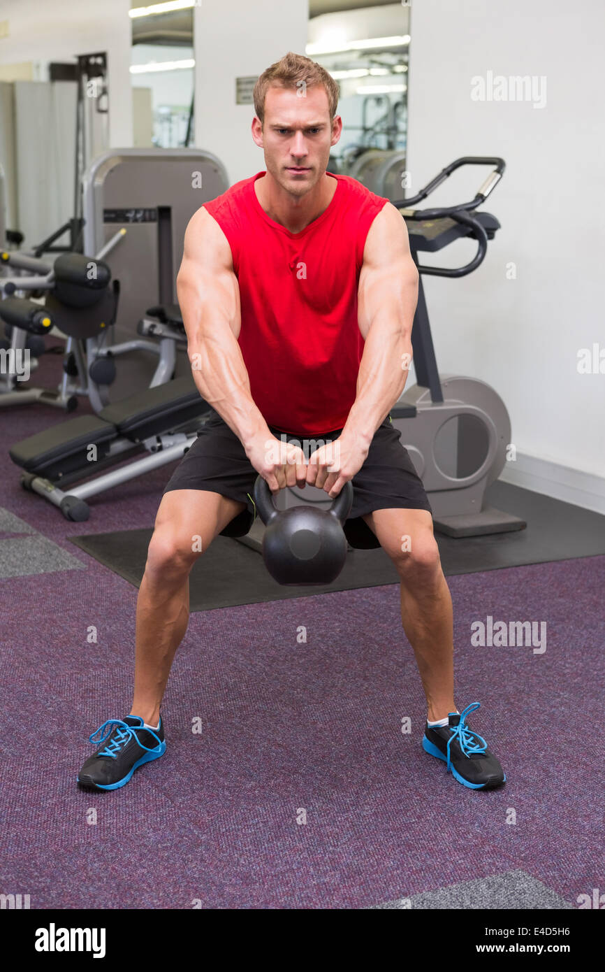 Strong man lifting heavy kettlebell Stock Photo Alamy