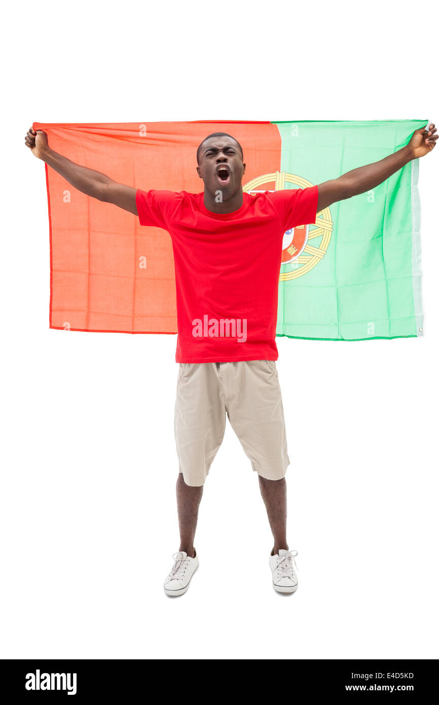 Excited portugal football fan in red cheering Stock Photo