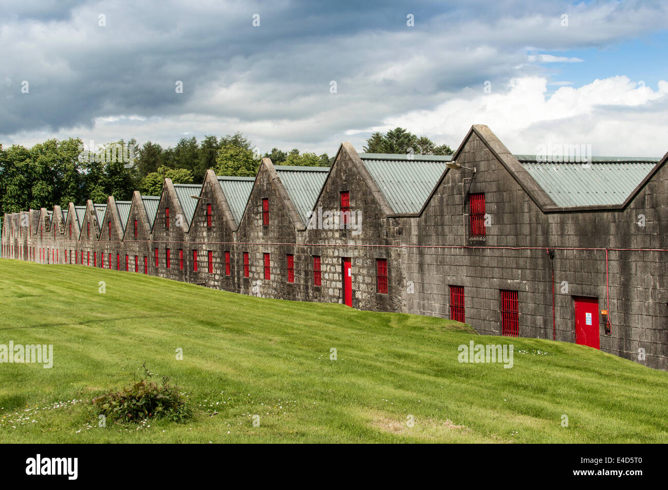 SCOTTISH WHISKY WAREHOUSES WITH RED WINDOWS AND DOORS IN KENNETHMONT ABERDEENSHIRE Stock Photo