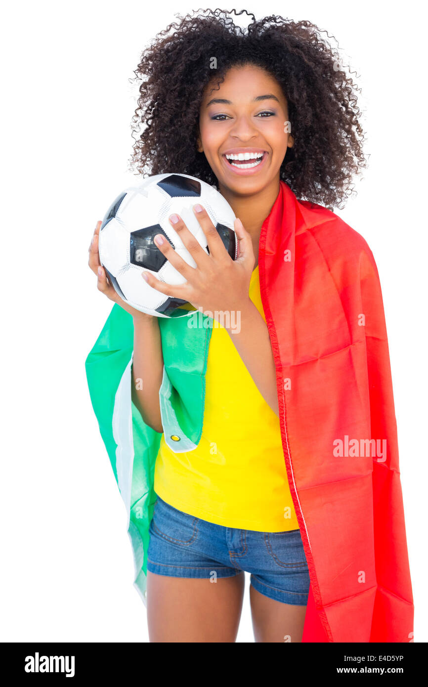 Pretty football fan with portugal flag holding ball Stock Photo