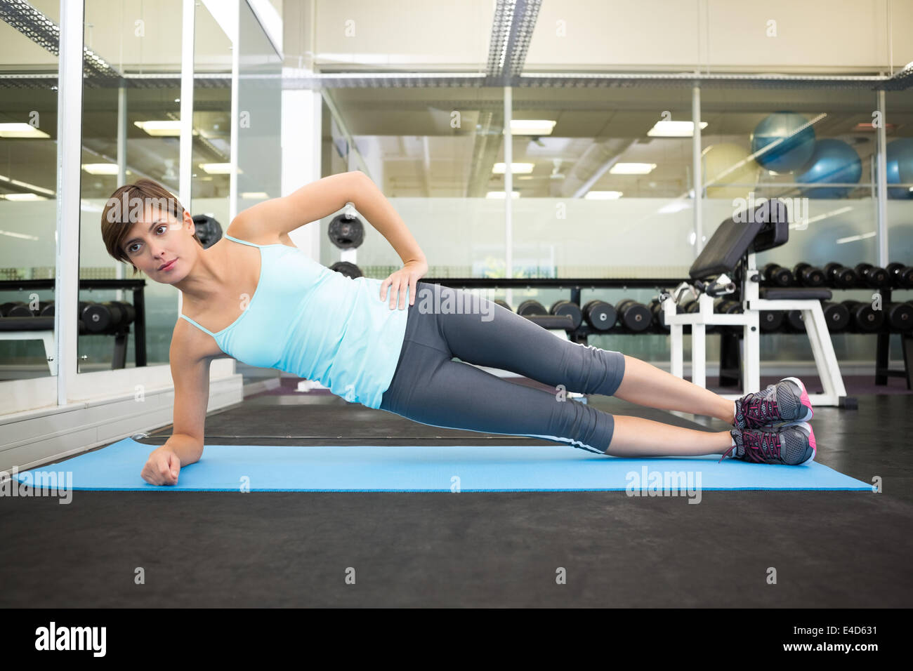 Fit brunette doing pilates on exercise mat Stock Photo