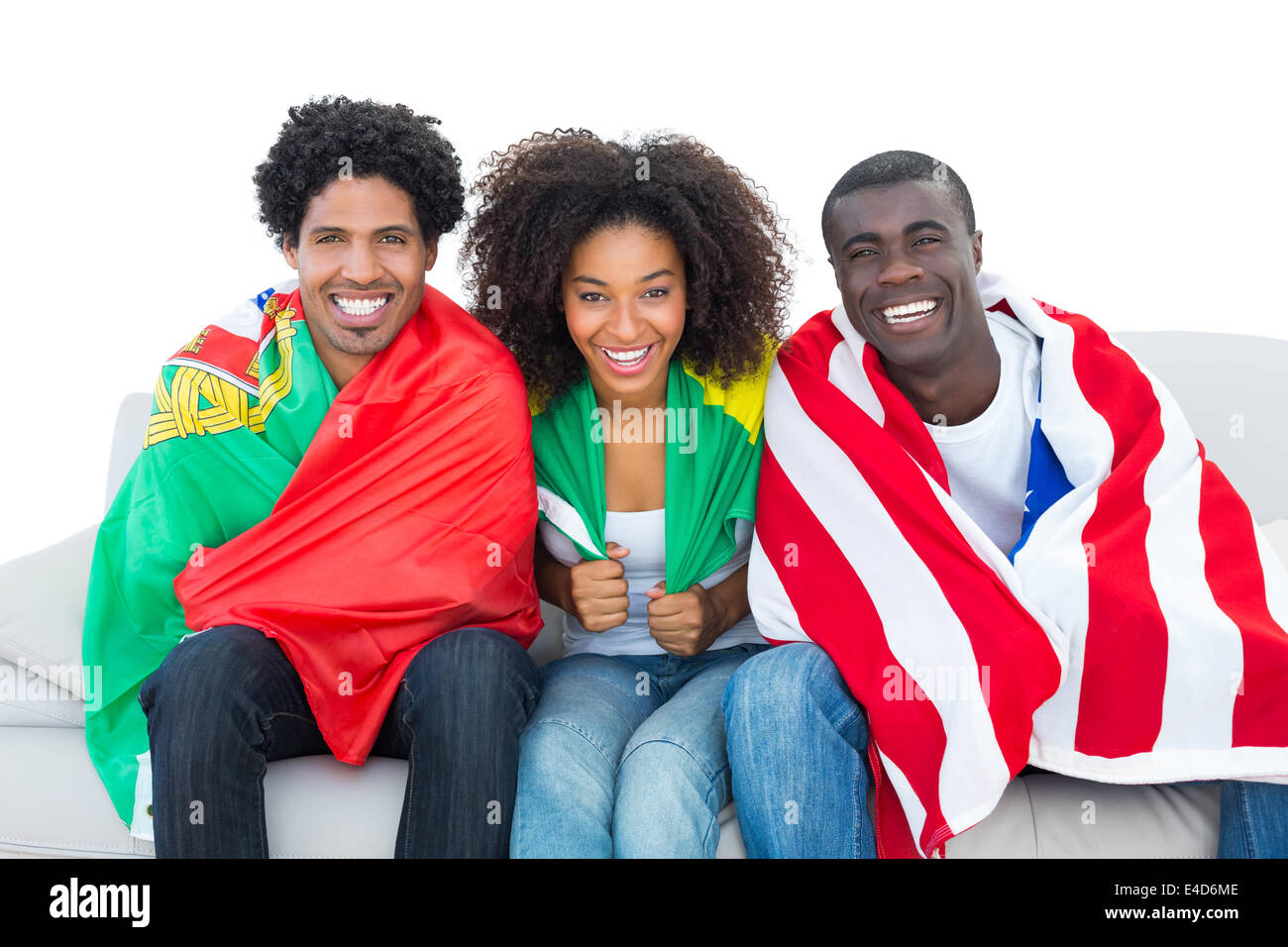 Happy fans wrapped in flags smiling at camera Stock Photo - Alamy
