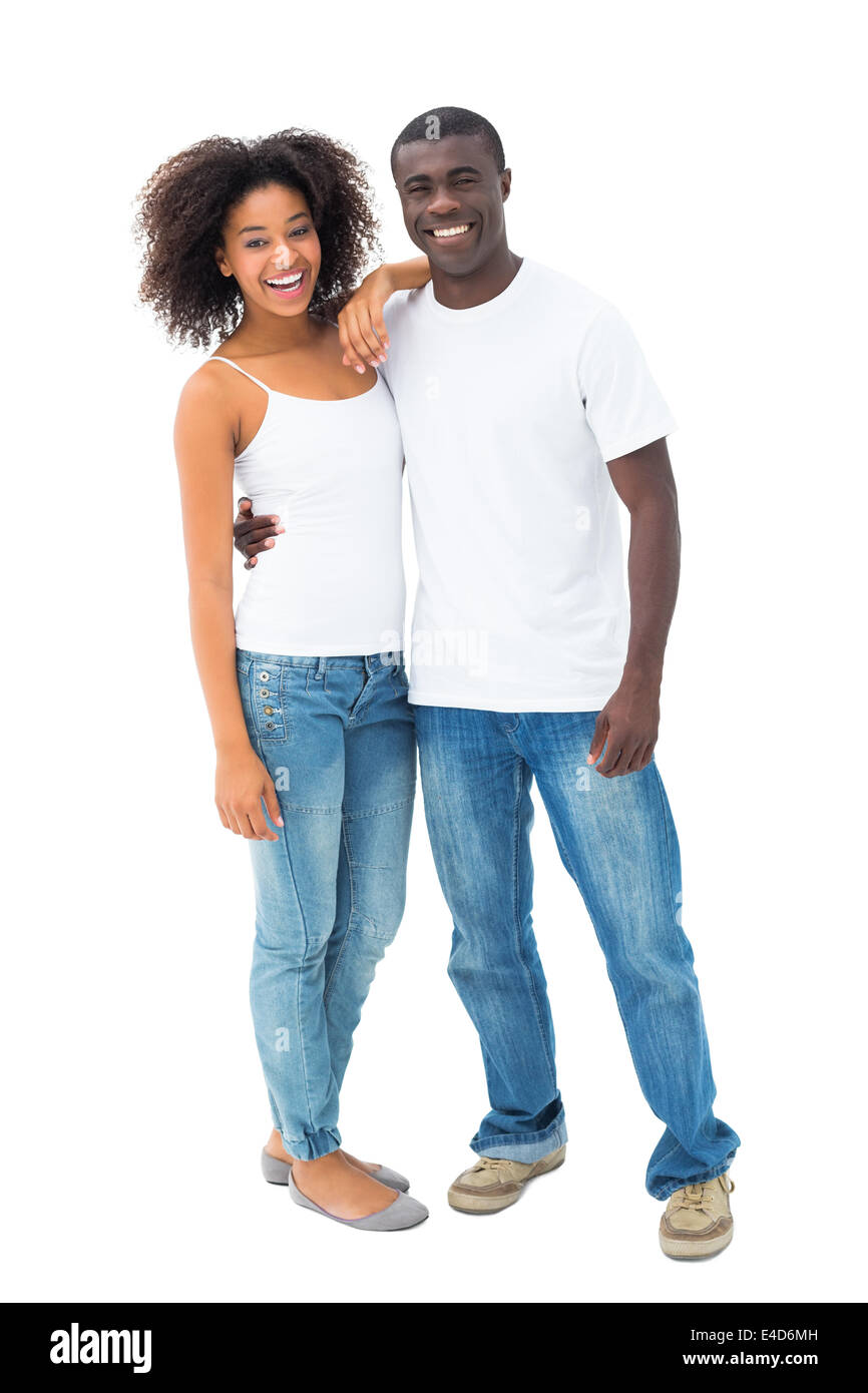 Casual couple in jeans and white tops smiling at camera Stock Photo