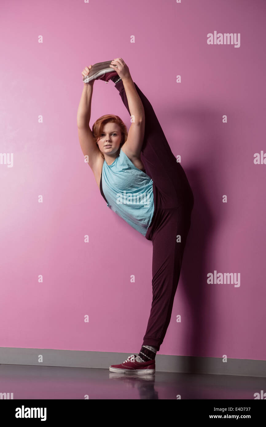 Pretty break dancer lifting her leg above head Stock Photo