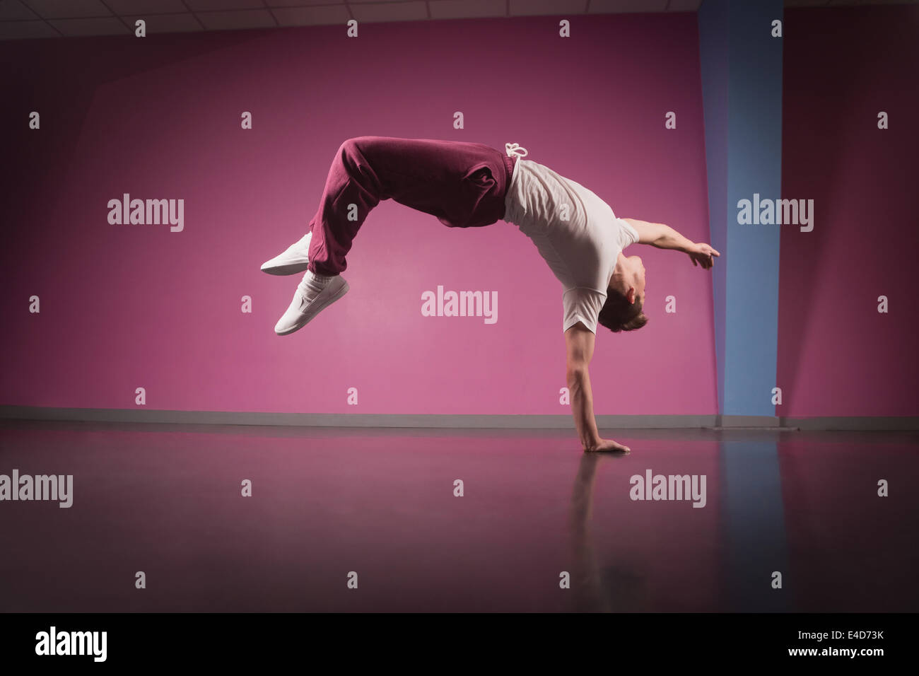 Cool break dancer doing handstand on one hand Stock Photo