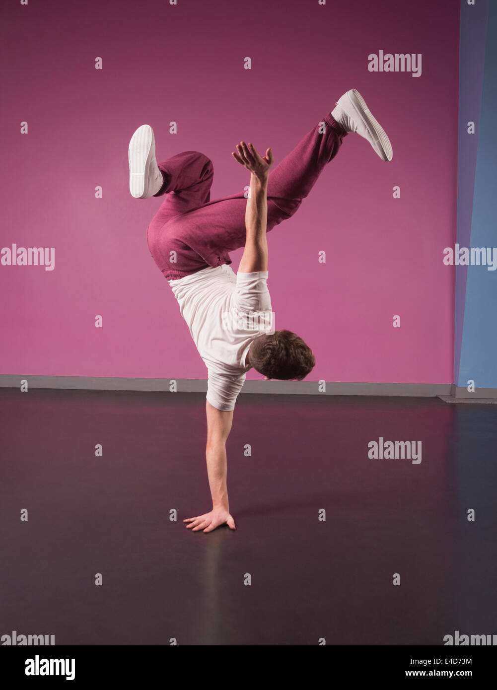 Cool break dancer doing handstand on one hand Stock Photo
