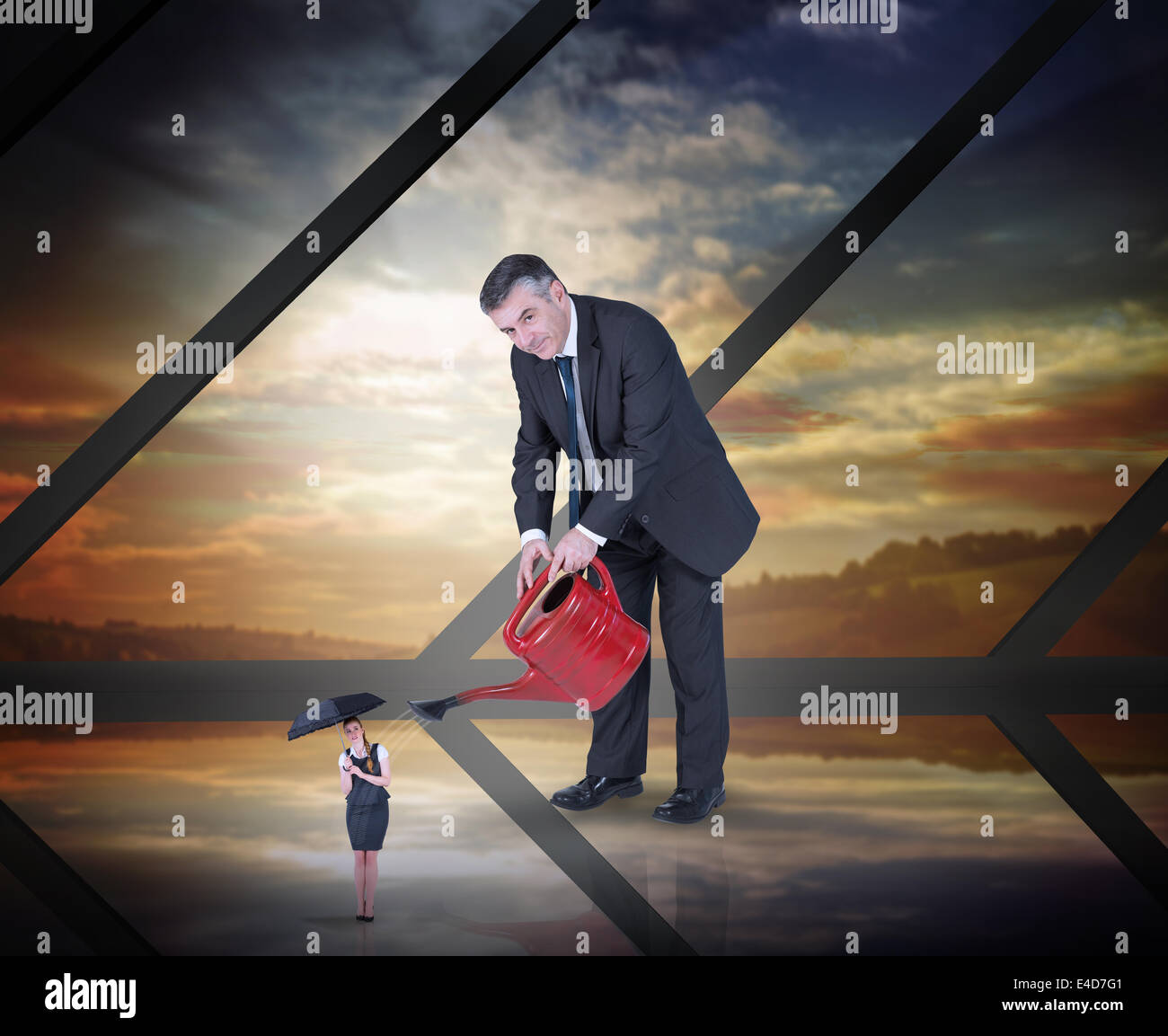 Composite image of mature businessman watering tiny businesswoman Stock Photo