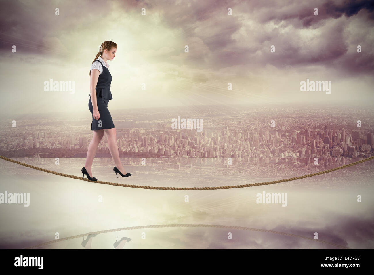 Composite image of redhead businesswoman stepping on tightrope Stock Photo