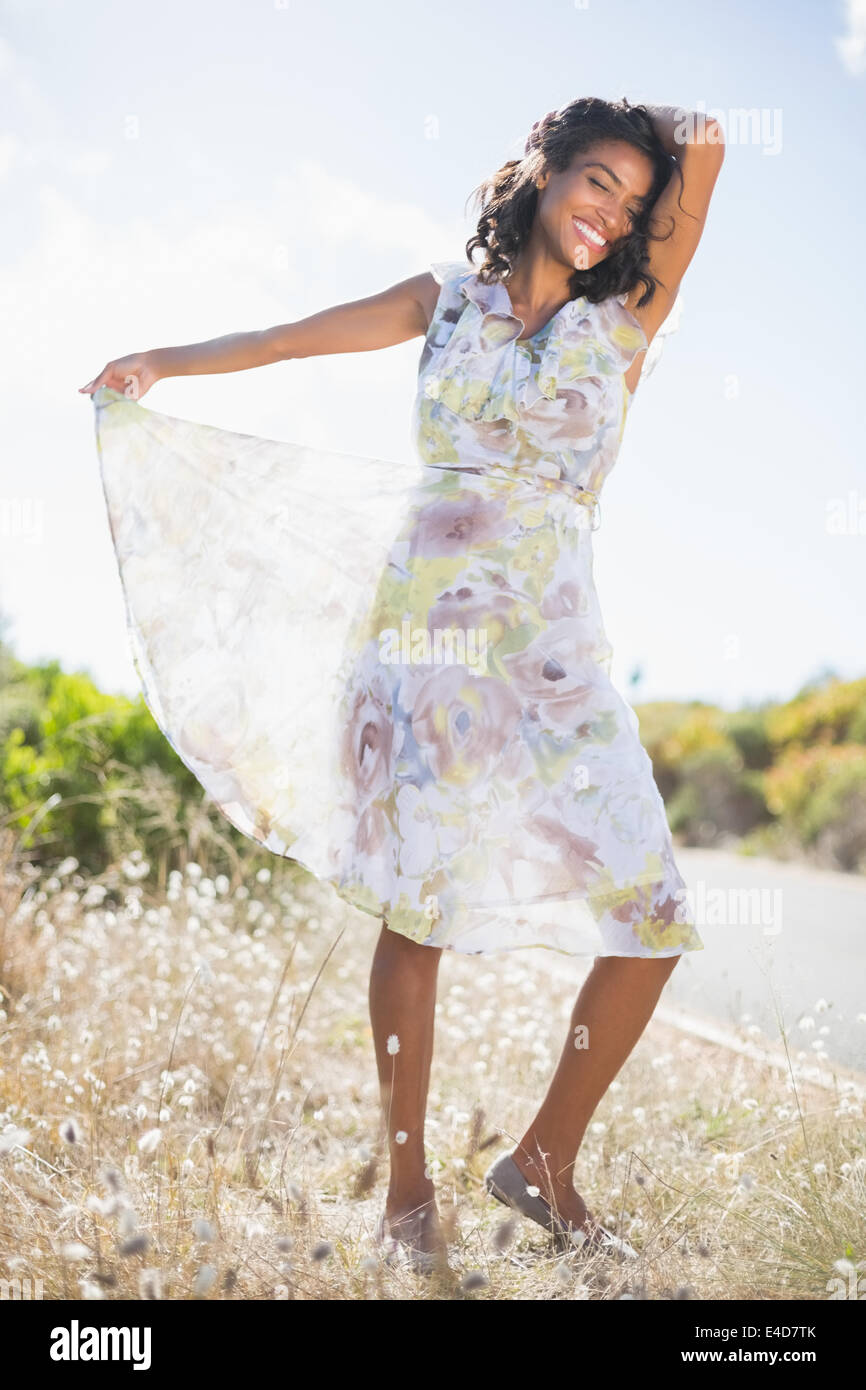 Beautiful woman in floral dress smiling at camera Stock Photo