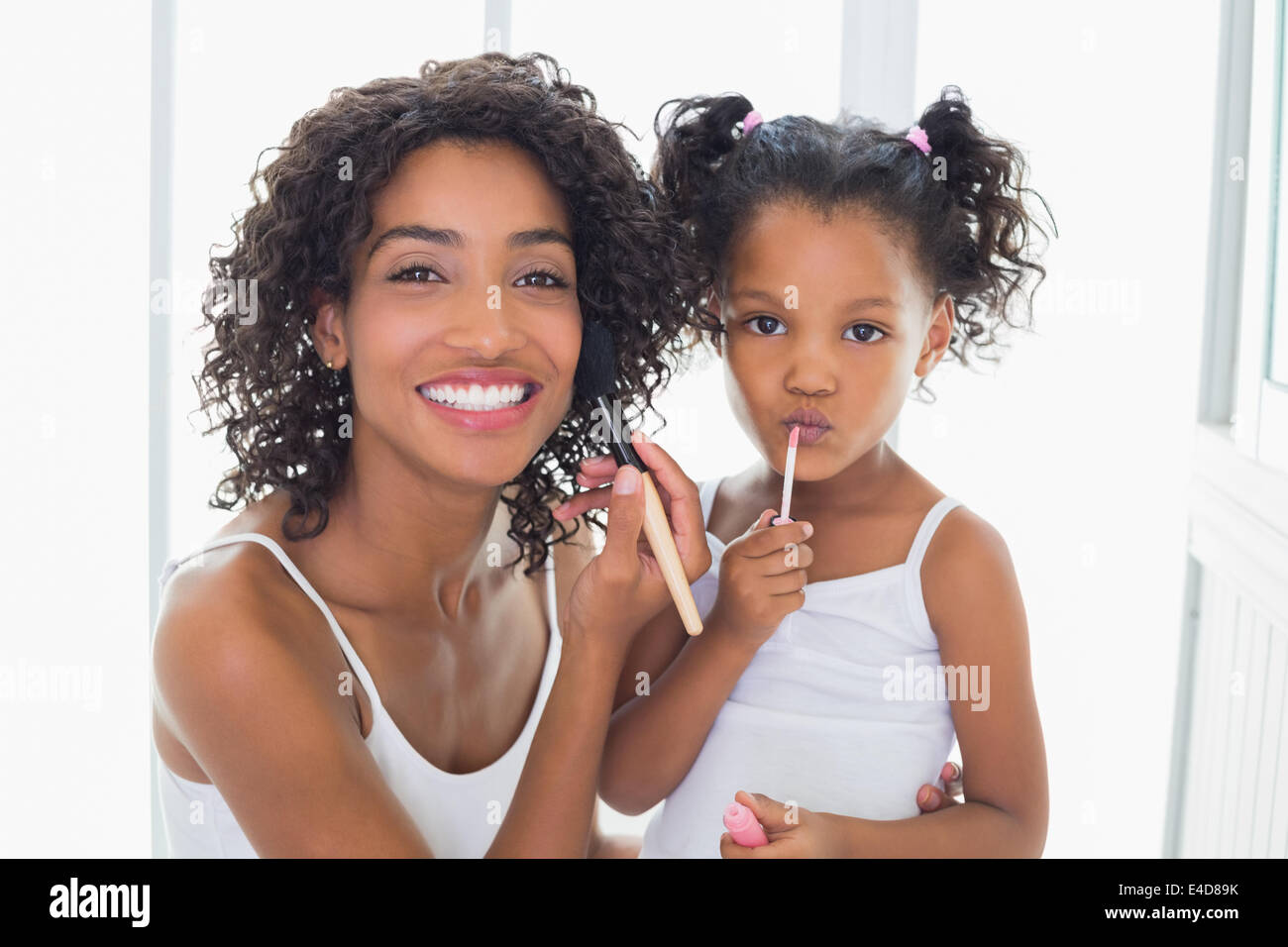 Pretty mother teaching her daughter about makeup Stock Photo