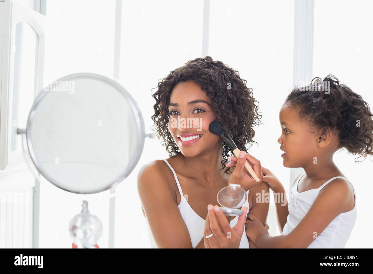 Pretty mother teaching her daughter about makeup Stock Photo