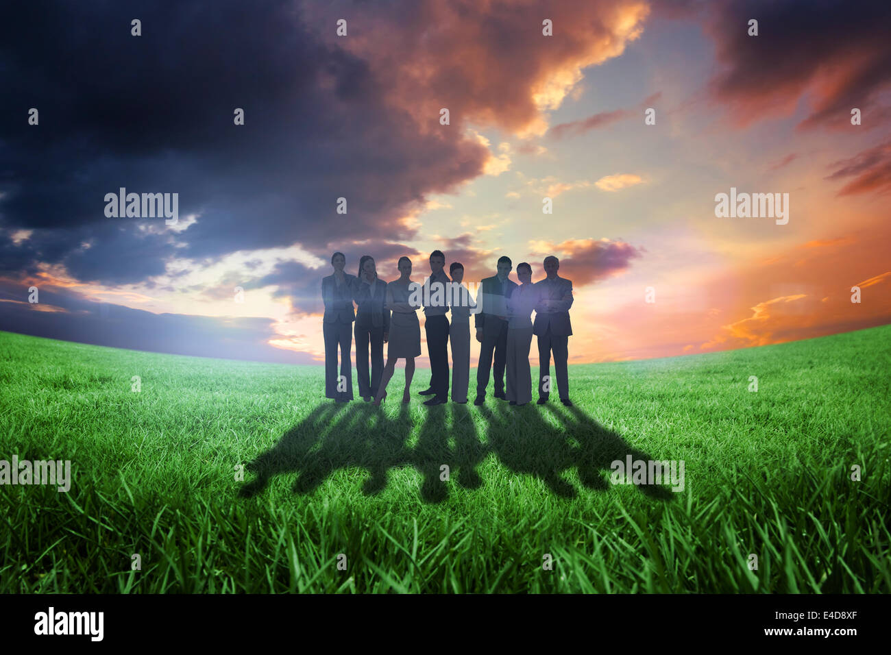 Composite image of business team looking at camera Stock Photo - Alamy