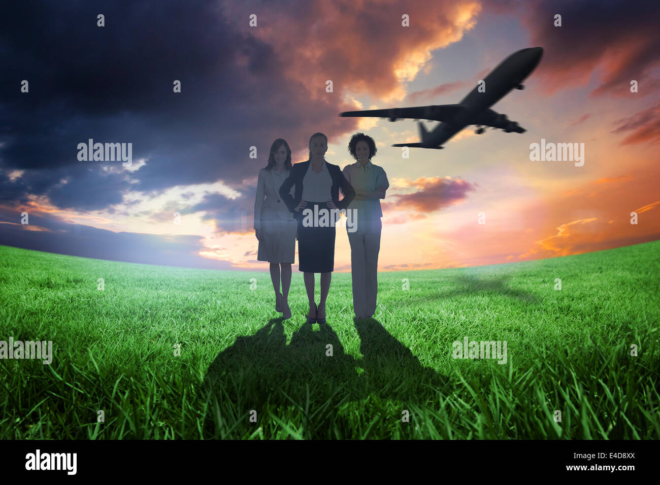Composite image of team of businesswomen looking at camera with airplane Stock Photo