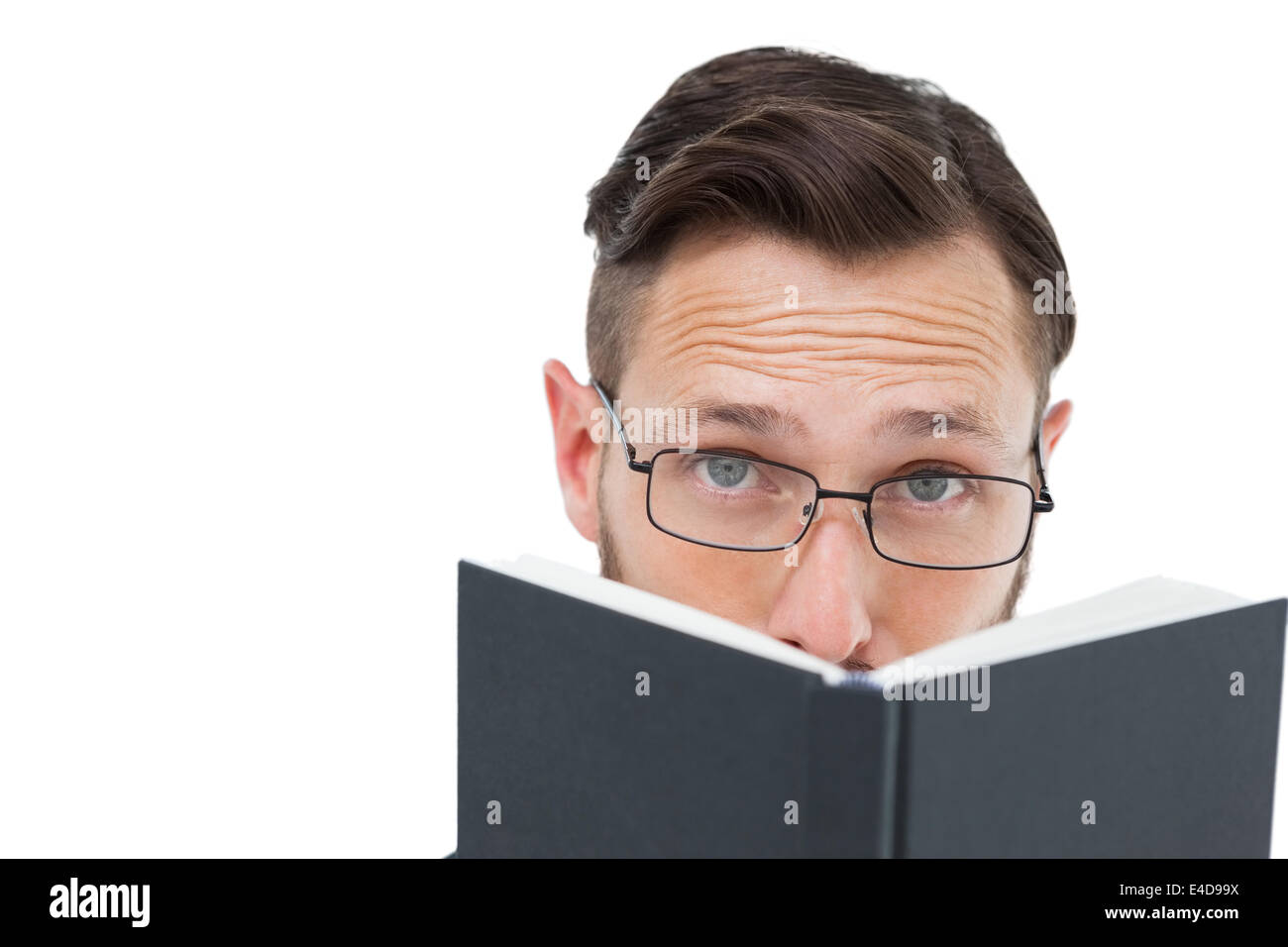 Young geek looking over black book Stock Photo