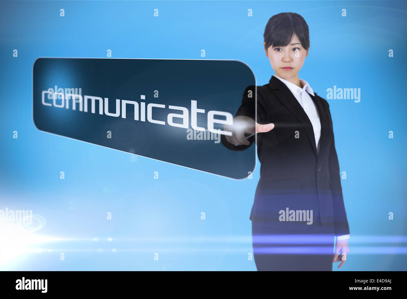 Businesswoman pointing to word communicate Stock Photo