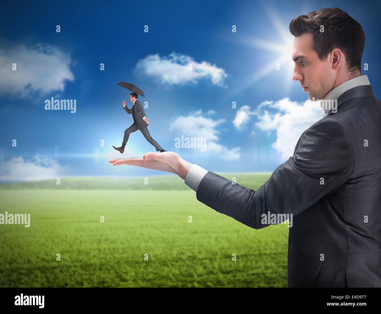 Composite image of businessman holding business man jumping Stock Photo