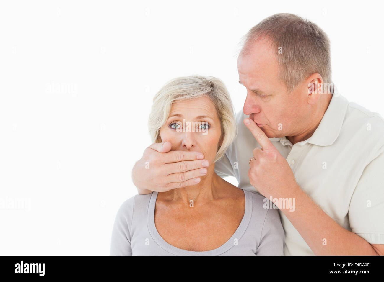 Man silencing his fearful partner Stock Photo