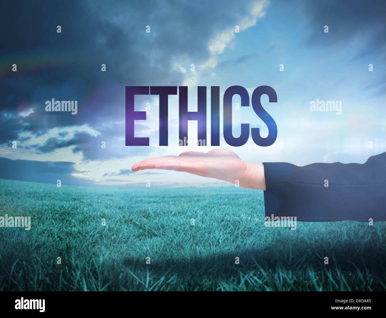Businesswomans hand presenting the word ethics Stock Photo