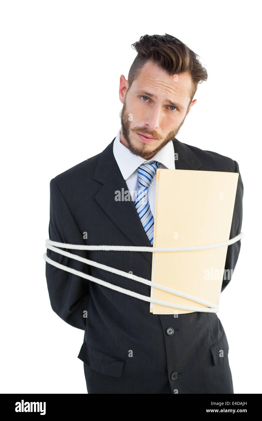 Serious businessman tied up at work Stock Photo