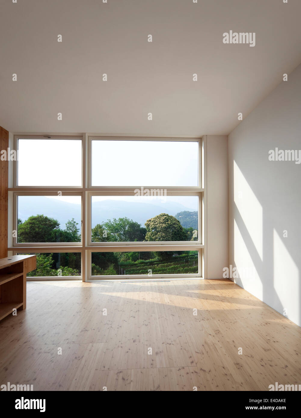 bright room with big window and natural parquet Stock Photo