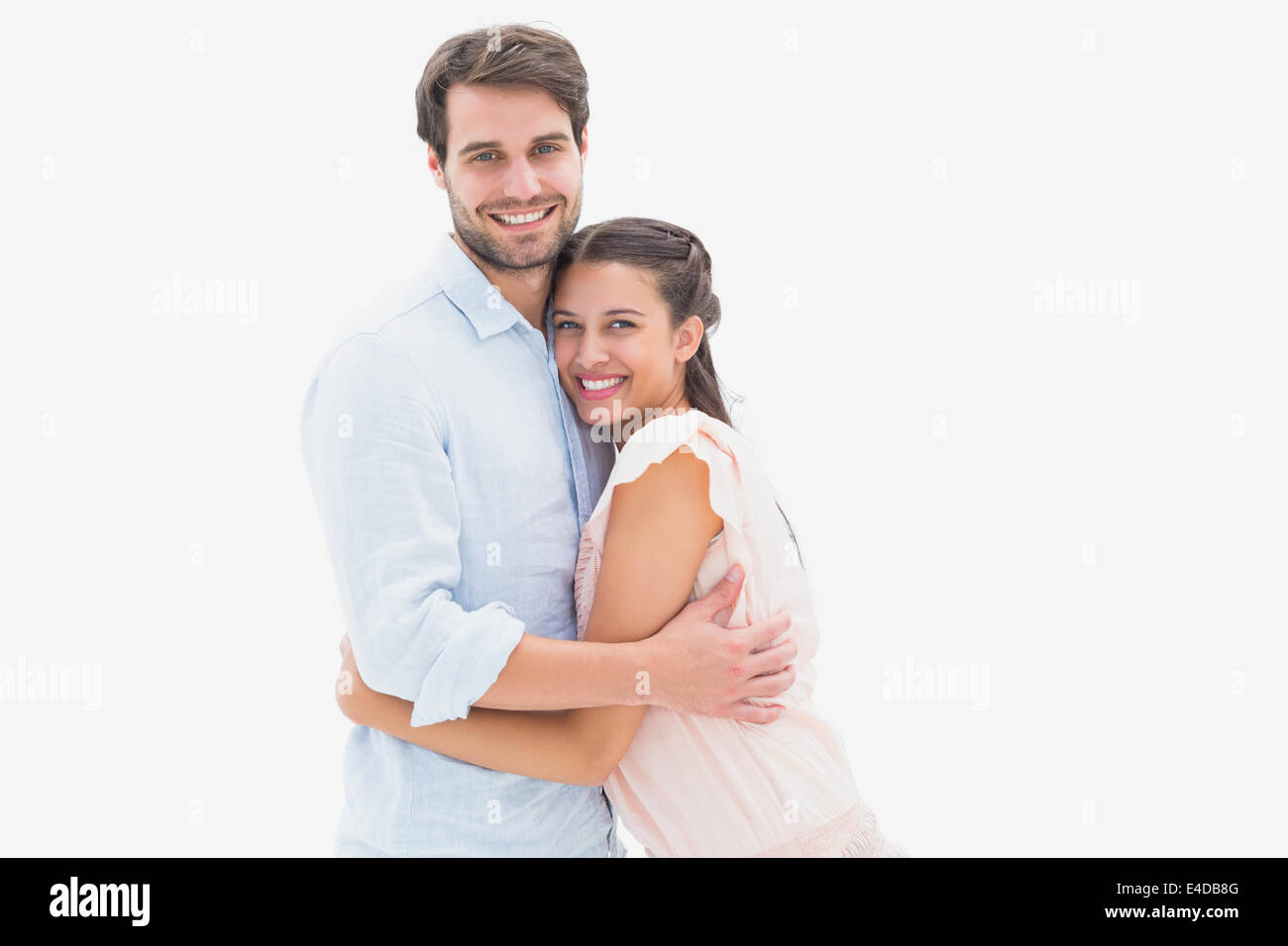 Attractive young couple hugging and smiling at camera Stock Photo - Alamy