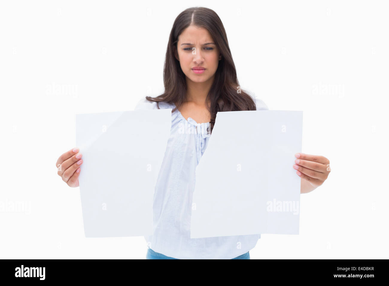 Upset brunette holding torn paper Stock Photo - Alamy