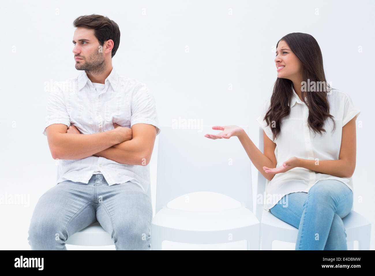 Brunette pleading with angry boyfriend Stock Photo