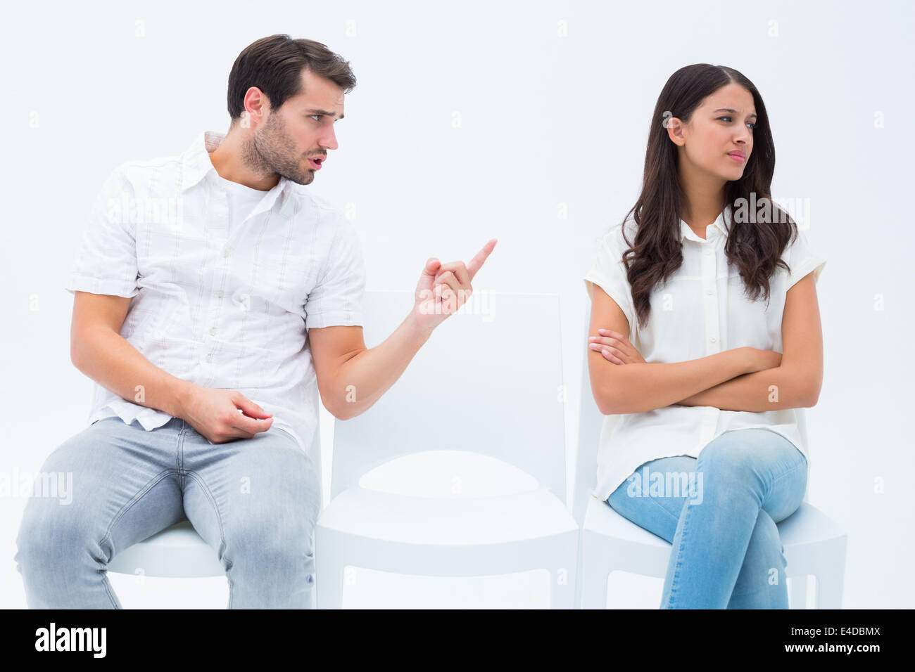 Man pleading with angry girlfriend Stock Photo