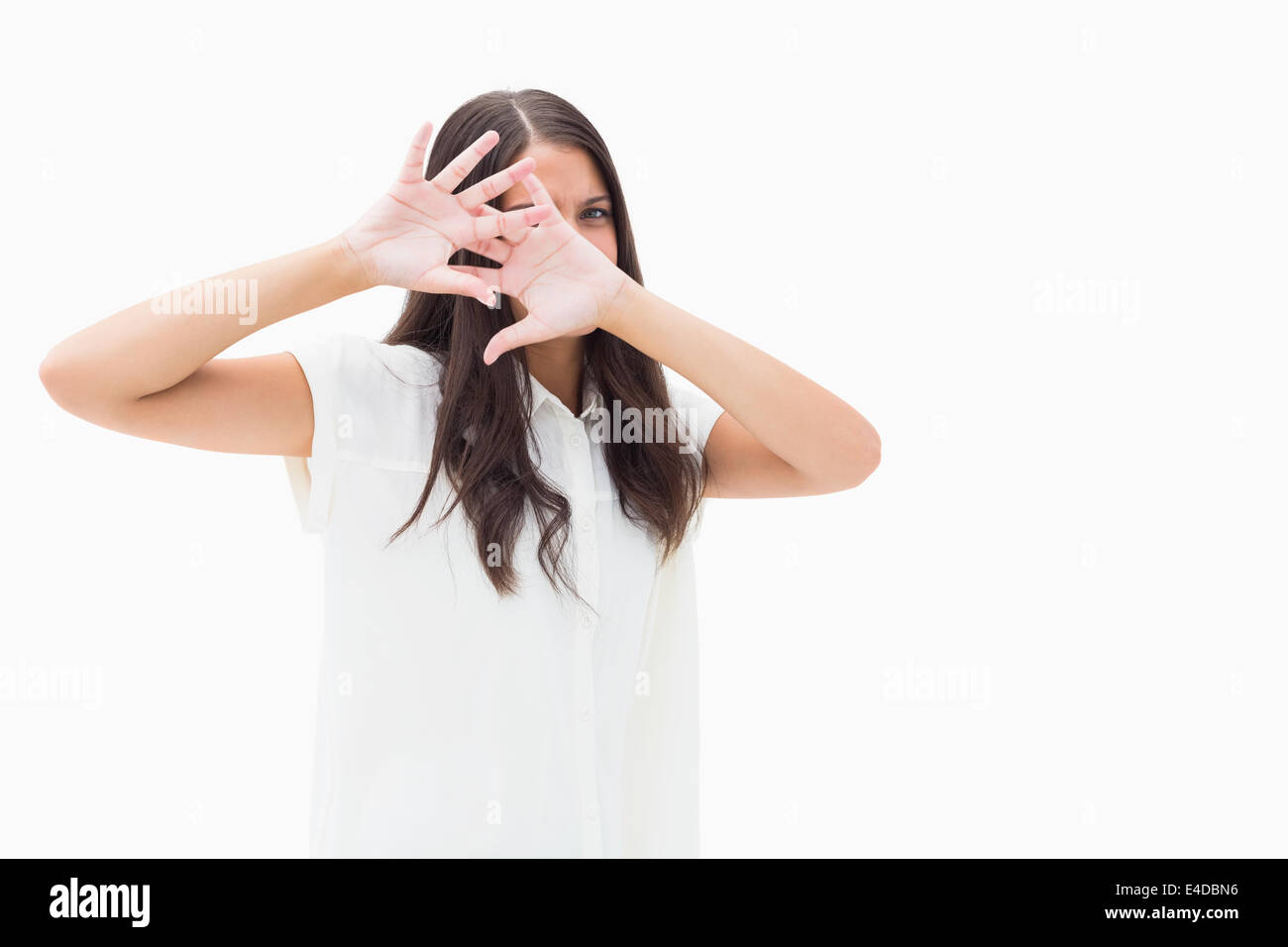 Fearful brunette covering her face Stock Photo
