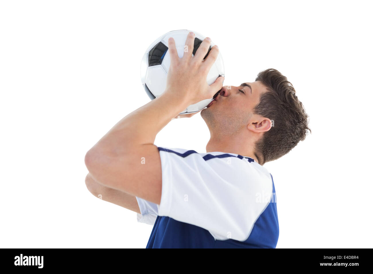 Football player in blue kissing the ball Stock Photo Alamy
