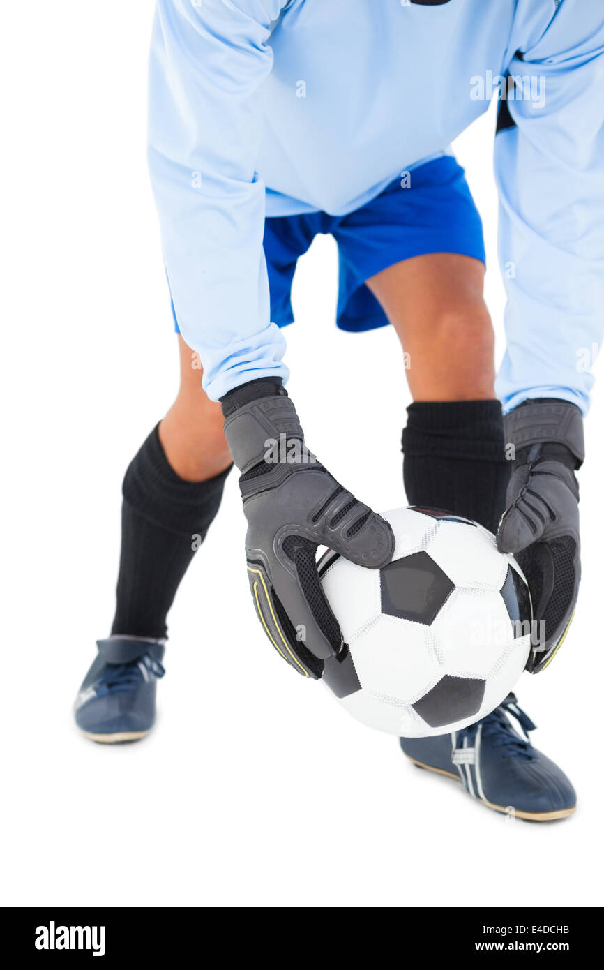 Goalkeeper picking up the ball Stock Photo