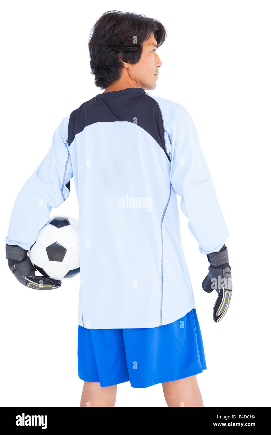 Goalkeeper in blue holding ball Stock Photo