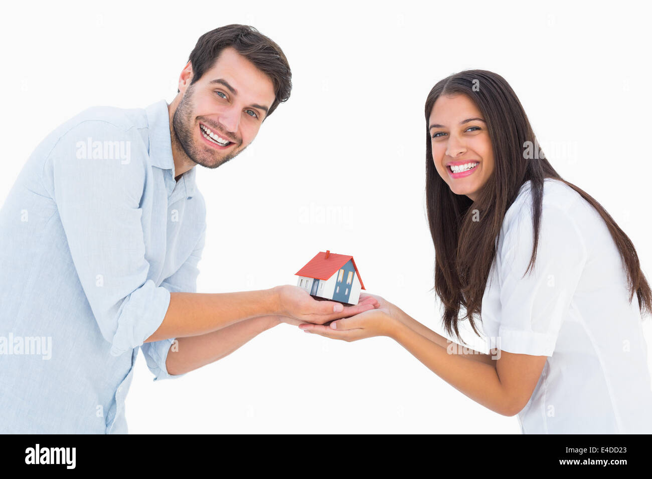 Attractive young couple holding a model house Stock Photo - Alamy