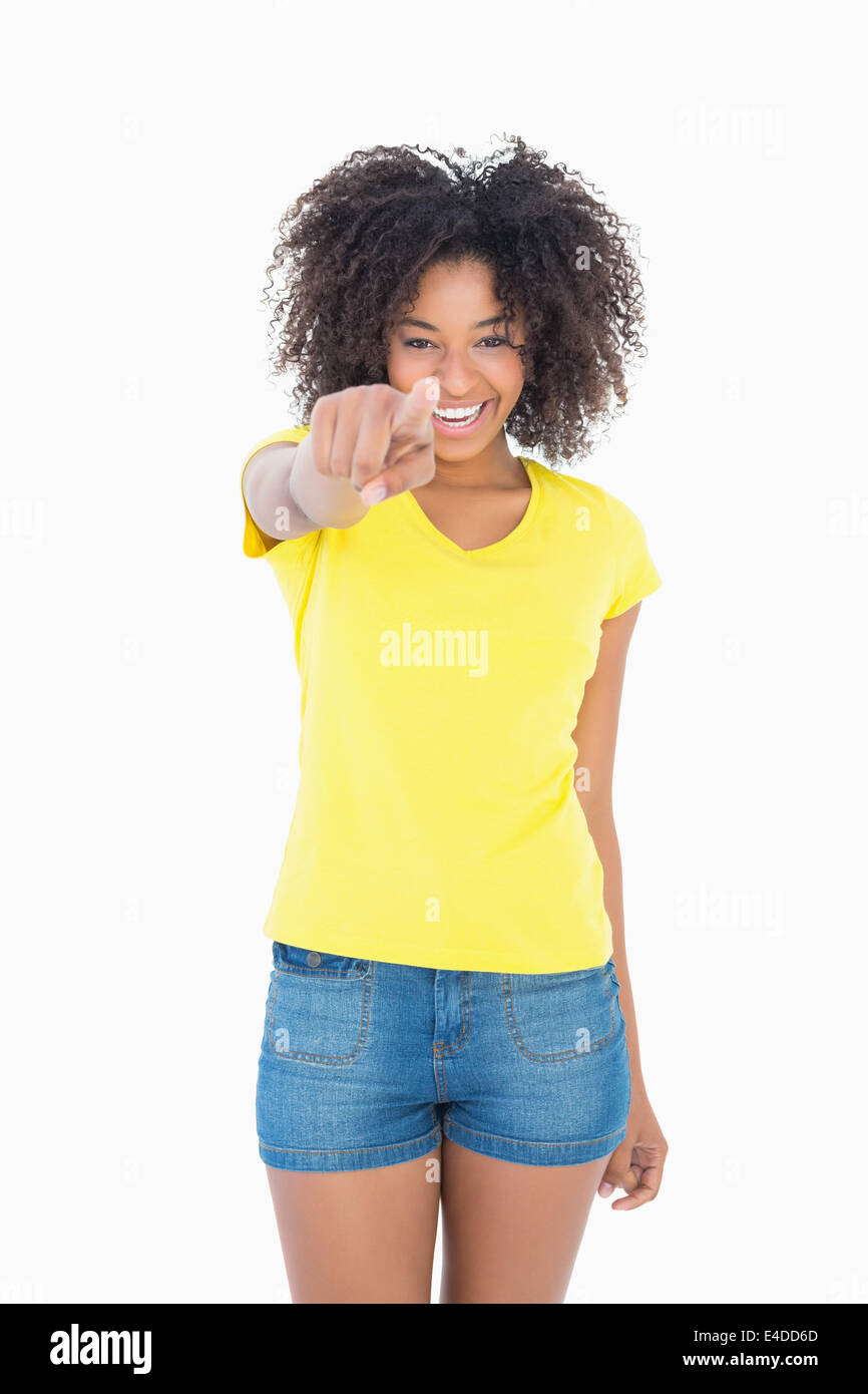 Pretty girl in yellow tshirt and denim hot pants pointing at camera Stock Photo Alamy