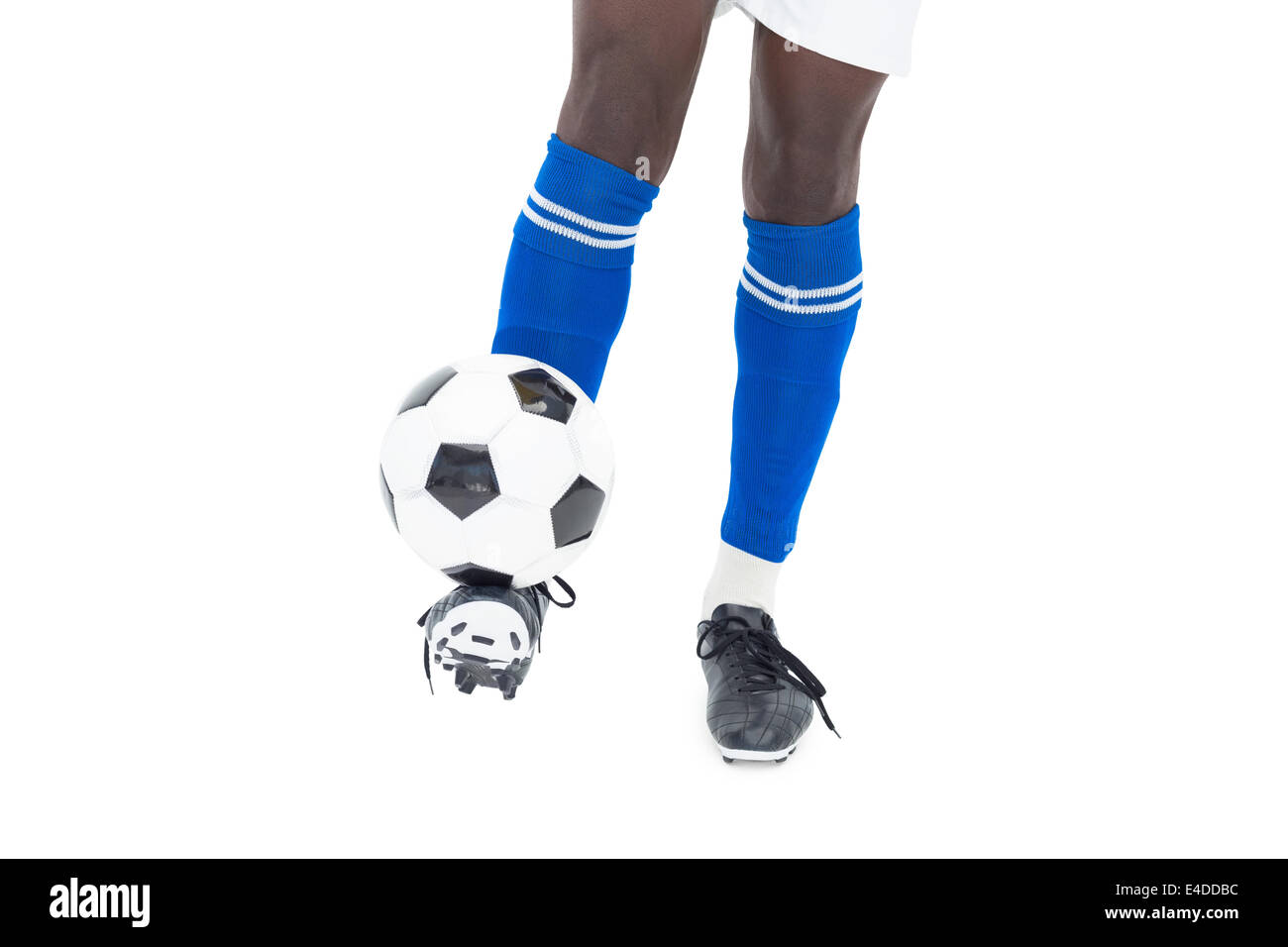 Football player in blue socks kicking ball Stock Photo Alamy