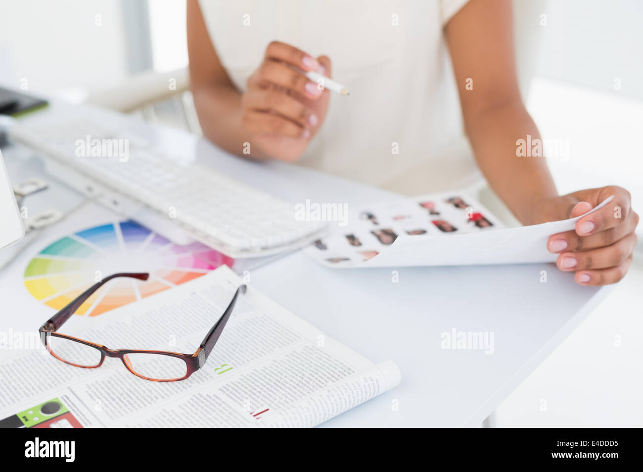 Photo editor working on contact sheet Stock Photo Alamy